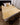 A Wool mattress topper placed on a bed, shaped as a rectangle covering the entire bed, known as the best mattress topper for back pain adopted by hospitals and institutions globally from kiwi sheepskins