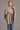 a model wearing a mocha Possum Merino Split Front Wrap from Kiwi Sheepskins, drapes elegantly, offering both style and comfort