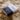 A nicely packaged brown box with a cover of dark blue and white McDonald New Zealand label, on top of Sheepskin rugs from kiwi sheepskins, perfect as gift for newborn bundle