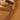 Close-up on the fabric of a chestnut color Sheepskin Slippers, showcasing the crafted even stitch details #color_chestnut