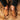 A top view of a worn chestnut color Sheepskin Slippers for men on a fluffy brown Sheepskin rugs from kiwi sheepskins #color_chestnut