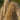 Close-up of a person holding a beige Sheepskin rugs with long sheepskin wool from kiwi sheepskins #color_sand
