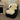 An aesthetic large ivory white sheepskin rug draped over a black armchair in a room with a fireplace and a window #color_ivory-white