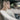 a woman inside the car driving on the road while resting her back against the Sheepskin Car Seat Covers from Kiwi Sheepskins, perfect for long drives and aesthetic car interior designs