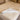 Medical sheepskin Wool mattress topper placed on a bed, crafted from authentic sheepskins, where each bed pad is composed of multiple sections of carefully stitched shorn medical-grade sheepskins from kiwi sheepskins