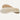 A pair of beige sheepskin insoles for shoes or slippers, displayed on a wooden surface.